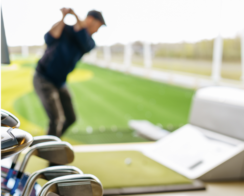 close-up photo of gold clubs and a golfer